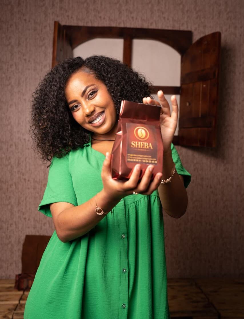 Model holding Sheba Coffee product